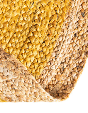 Handwoven oval jute area rug in mustard yellow with a natural beige braided border