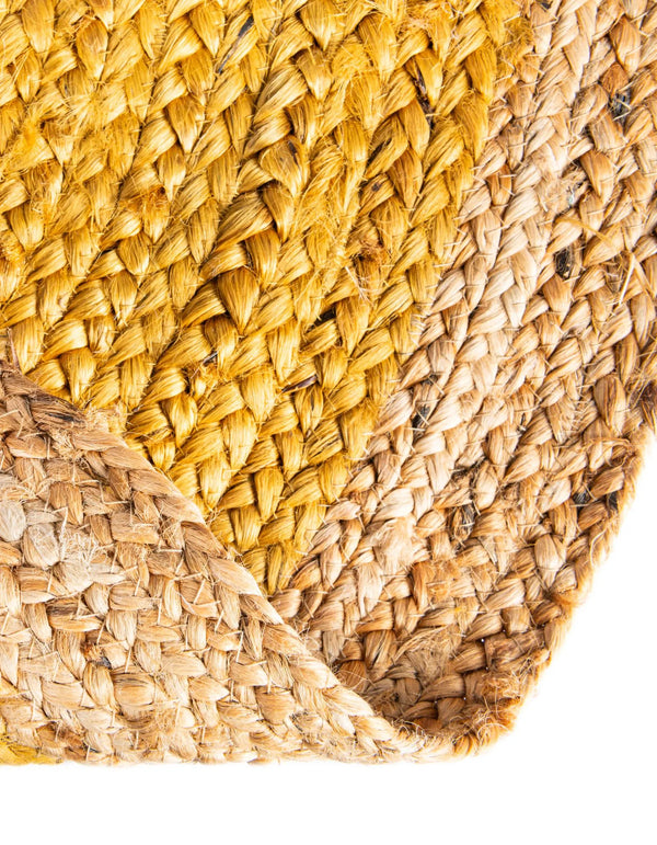 Handwoven oval jute area rug in mustard yellow with a natural beige braided border
