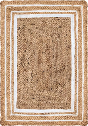 Natural woven jute rug with a navy blue double-border design, styled on a rustic wooden floor beside a wooden bench, striped throw blanket, and green potted fern.