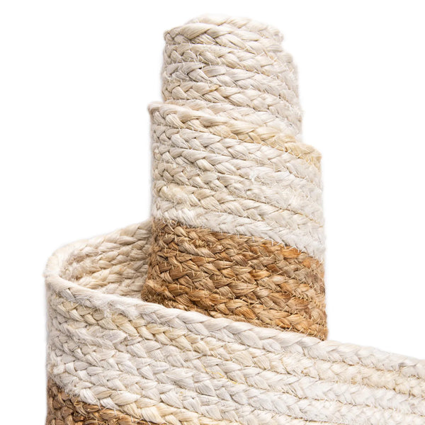 Hand-braided round jute and cotton area rug with alternating concentric natural brown and off-white striped circles.