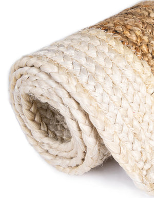 Hand-braided round jute and cotton area rug with alternating concentric natural brown and off-white striped circles.