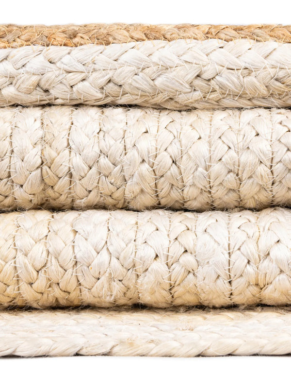 Hand-braided round jute and cotton area rug with alternating concentric natural brown and off-white striped circles.