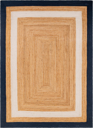 Handwoven natural jute area rug with ivory and navy blue borders styled in a bright coastal living room with a cream sofa and wooden furniture