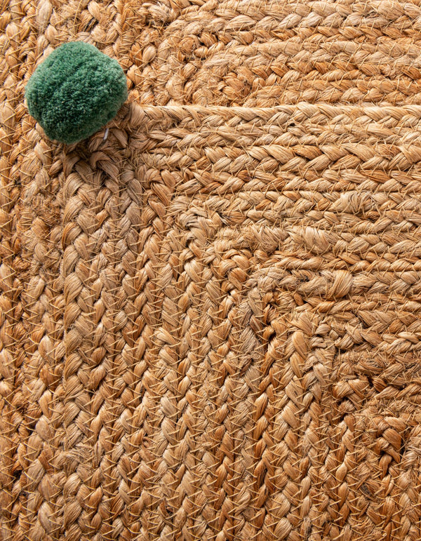 Handwoven natural jute runner rug with colorful pom-pom accents laid in a bright white hallway on light oak flooring