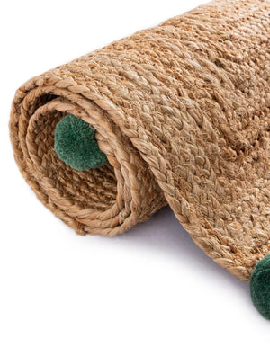 Handwoven natural jute runner rug with colorful pom-pom accents laid in a bright white hallway on light oak flooring