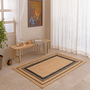 Handwoven geometric jute rug in natural and black tones