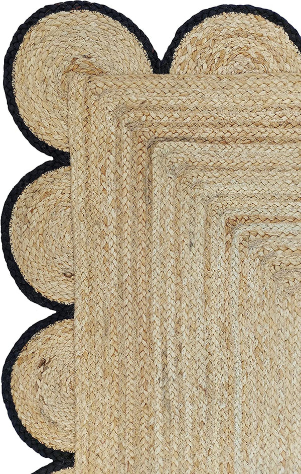 Handmade natural braided jute rug with black scalloped border displayed in a modern boho living room, eco-friendly woven area rug for living room, bedroom, farmhouse and minimalist home decor.
