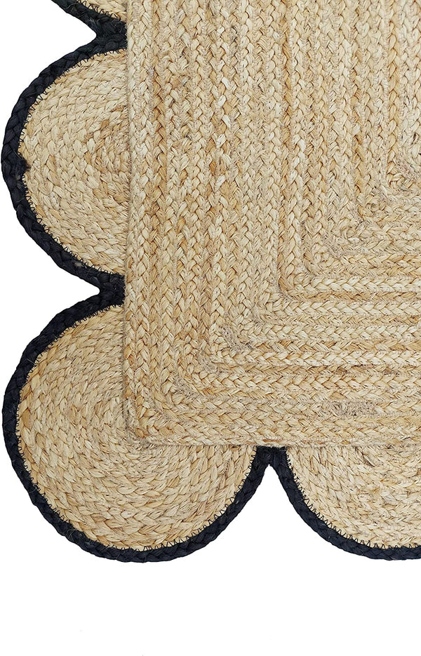 Handmade natural braided jute rug with black scalloped border displayed in a modern boho living room, eco-friendly woven area rug for living room, bedroom, farmhouse and minimalist home decor.