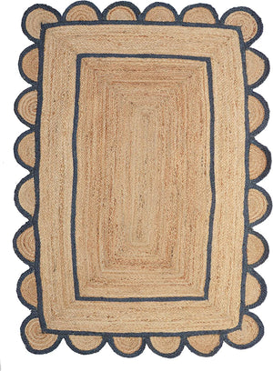 Handwoven natural jute area rug with navy blue scalloped border, eco-friendly braided rectangular rug for modern boho farmhouse living room decor.