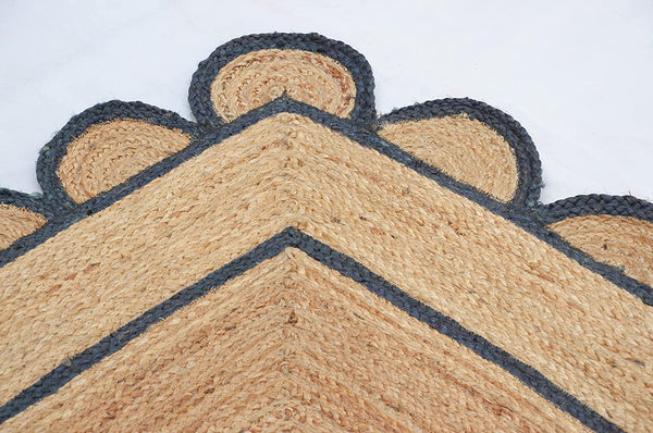 Handwoven natural jute area rug with navy blue scalloped border, eco-friendly braided rectangular rug for modern boho farmhouse living room decor.