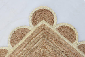 Handwoven natural jute area rug in beige and off-white with scalloped edge border for living room and bedroom