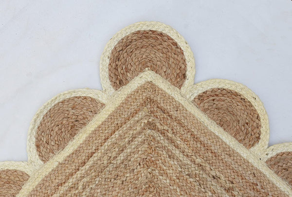 Handwoven natural jute area rug in beige and off-white with scalloped edge border for living room and bedroom