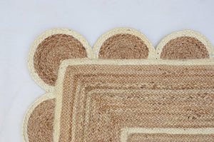 Handwoven natural jute area rug in beige and off-white with scalloped edge border for living room and bedroom
