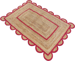 Handwoven natural jute area rug with bold red scalloped border and braided rectangular design