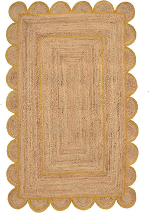 Handmade natural jute scalloped area rug with mustard border in a modern boho living room