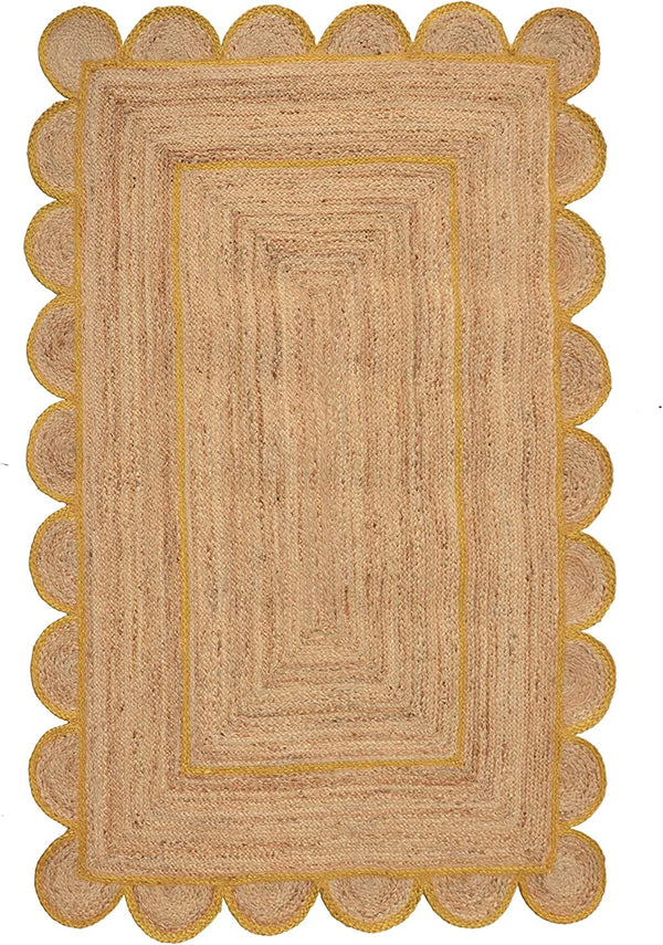 Handmade natural jute scalloped area rug with mustard border in a modern boho living room