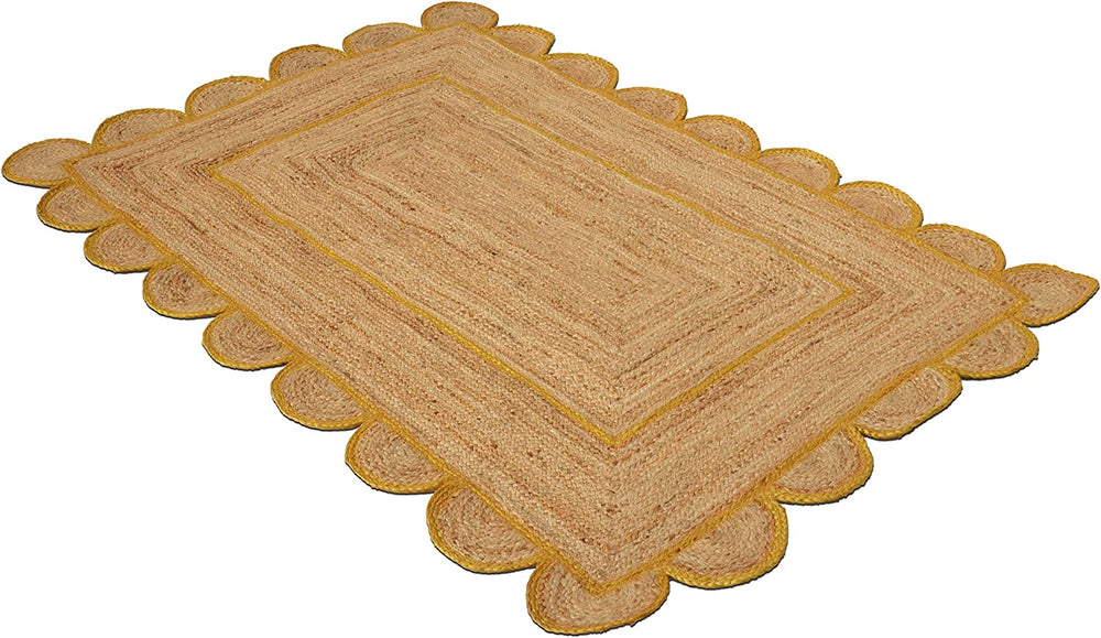 Handmade natural jute scalloped area rug with mustard border in a modern boho living room