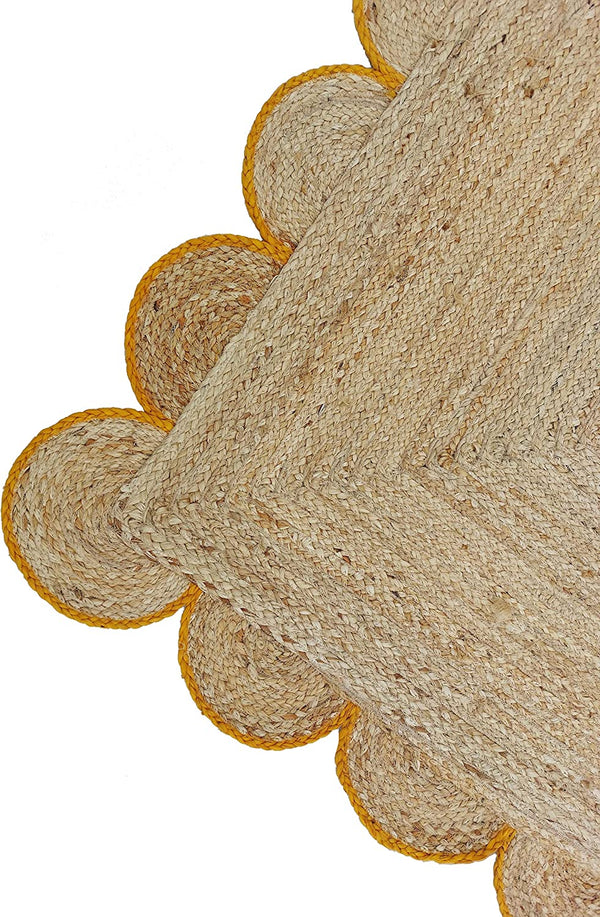 Handwoven Natural Jute Area Rug with Mustard Scalloped Border Styled in a Modern Scandinavian Living Room