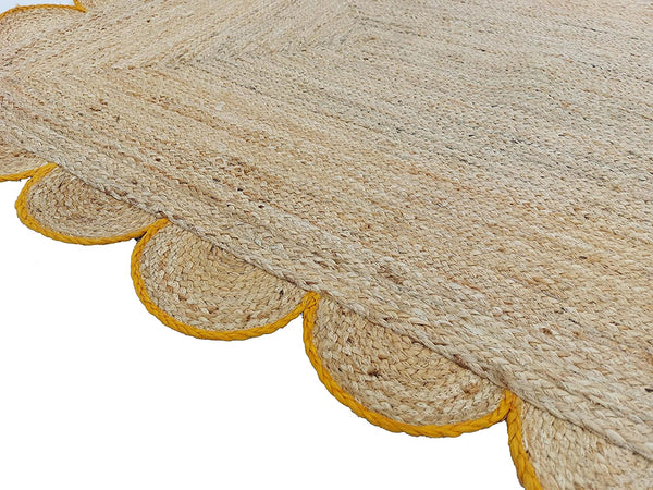 Handwoven Natural Jute Area Rug with Mustard Scalloped Border Styled in a Modern Scandinavian Living Room