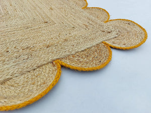 Handwoven Natural Jute Area Rug with Mustard Scalloped Border Styled in a Modern Scandinavian Living Room