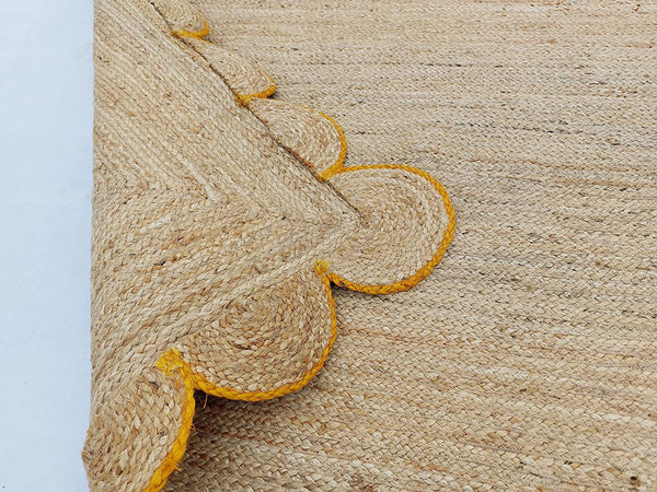 Handwoven Natural Jute Area Rug with Mustard Scalloped Border Styled in a Modern Scandinavian Living Room