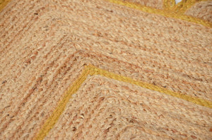 Handmade natural jute scalloped area rug with mustard border in a modern boho living room