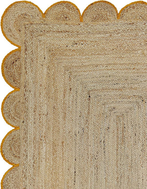 Handwoven Natural Jute Area Rug with Mustard Scalloped Border Styled in a Modern Scandinavian Living Room
