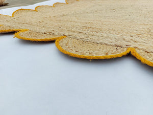 Handwoven Natural Jute Area Rug with Mustard Scalloped Border Styled in a Modern Scandinavian Living Room