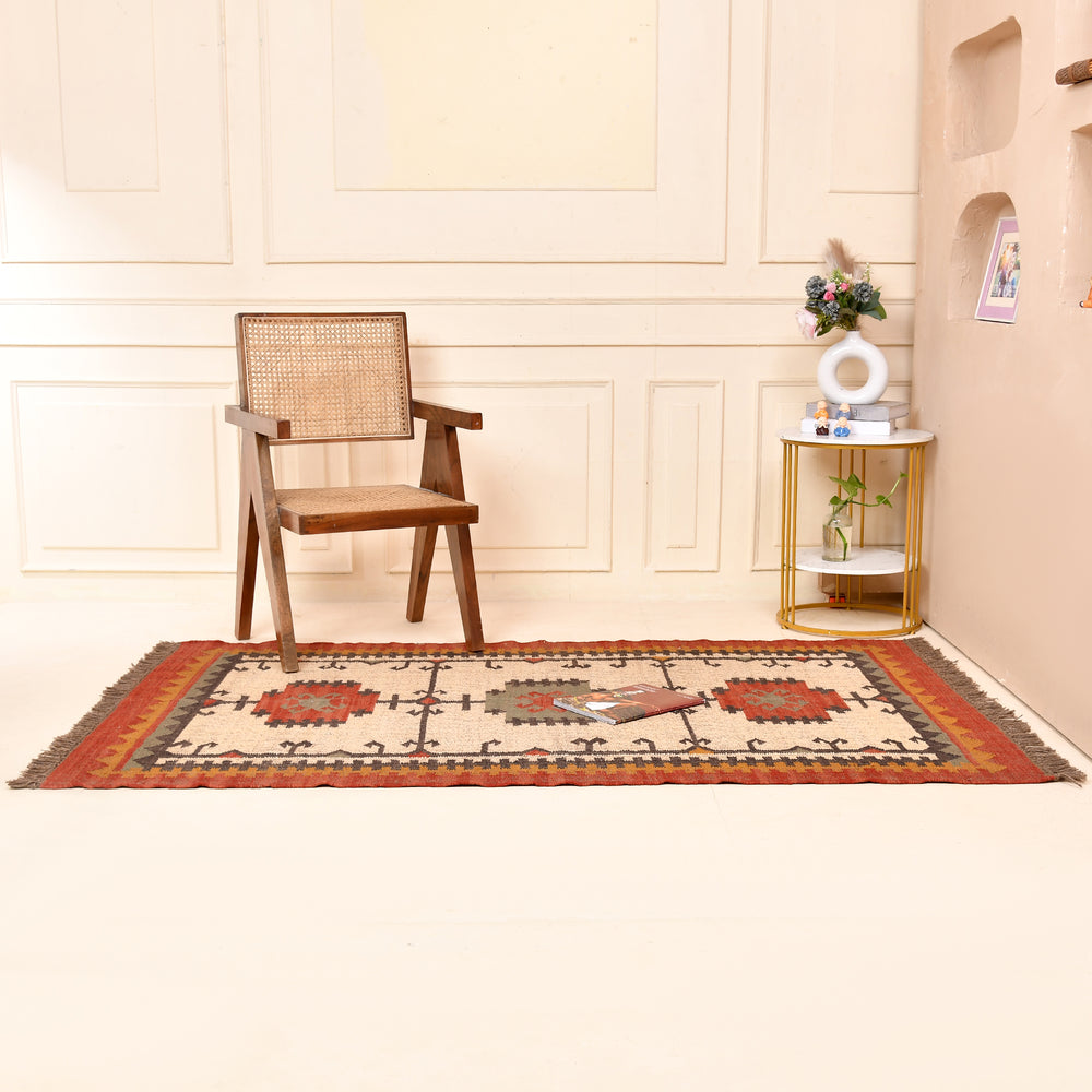 Handwoven ivory wool Kilim area rug featuring tribal geometric medallions and traditional border design, styled in a modern living room.