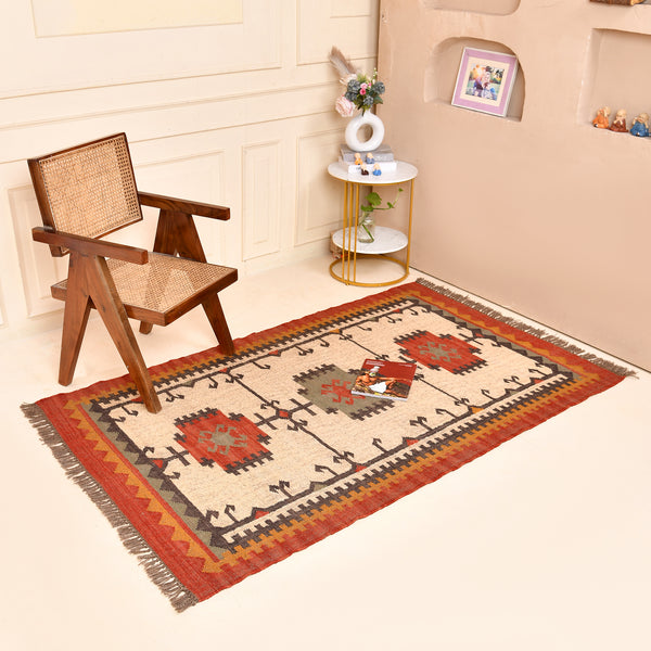 Handwoven ivory wool Kilim area rug featuring tribal geometric medallions and traditional border design, styled in a modern living room.