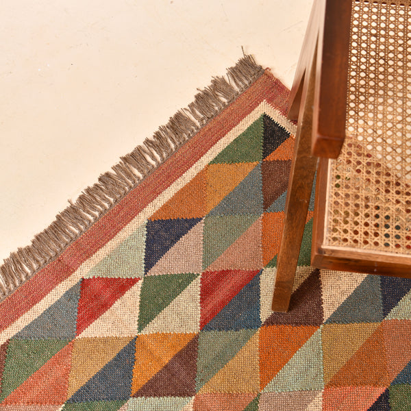 Handwoven multicolor geometric kilim area rug featuring colorful triangle patterns in wool and natural jute for living room, bedroom, hallway, and modern home décor.