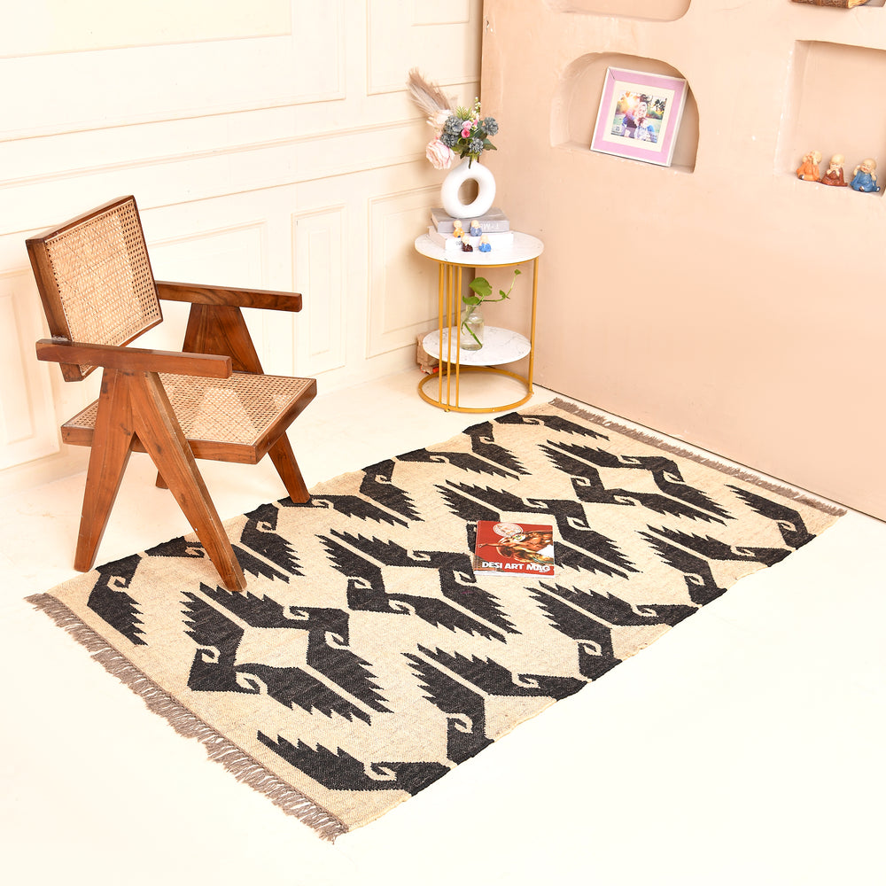 Handwoven black and ivory geometric kilim wool jute area rug in a modern living room with wooden chair and side table.