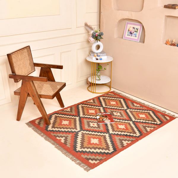 Handwoven geometric wool jute kilim area rug with tribal diamond pattern in terracotta, beige, charcoal, and ivory colors for living room and bedroom décor.