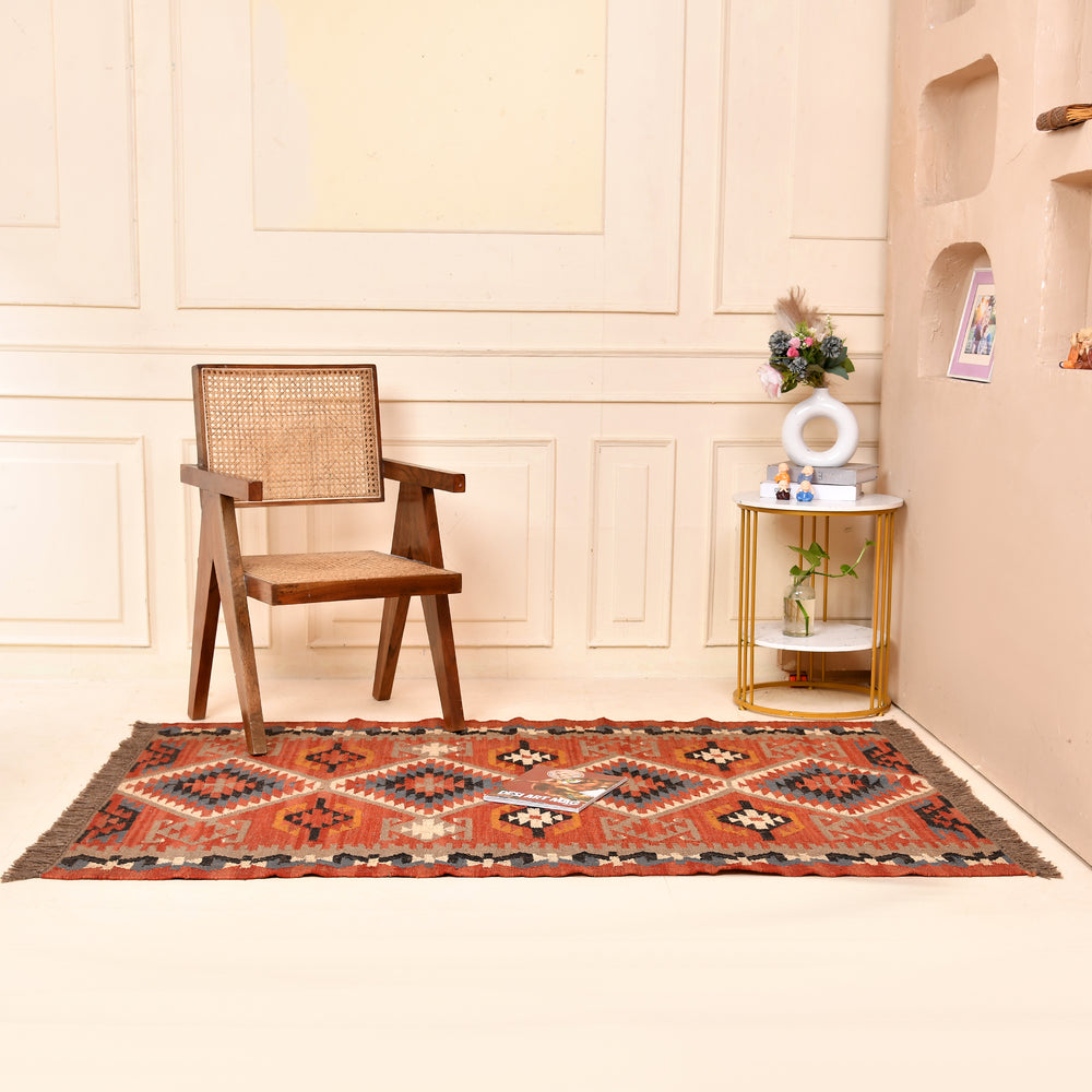 Handwoven terracotta geometric wool Kilim area rug with tribal diamond patterns and fringe, perfect for boho, farmhouse, rustic, and Southwestern home décor.