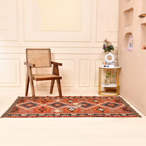 Handwoven terracotta geometric wool Kilim area rug with tribal diamond patterns and fringe, perfect for boho, farmhouse, rustic, and Southwestern home décor.