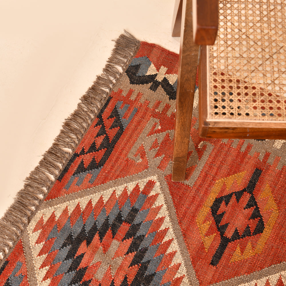 Handwoven terracotta geometric wool Kilim area rug with tribal diamond patterns and fringe, perfect for boho, farmhouse, rustic, and Southwestern home décor.