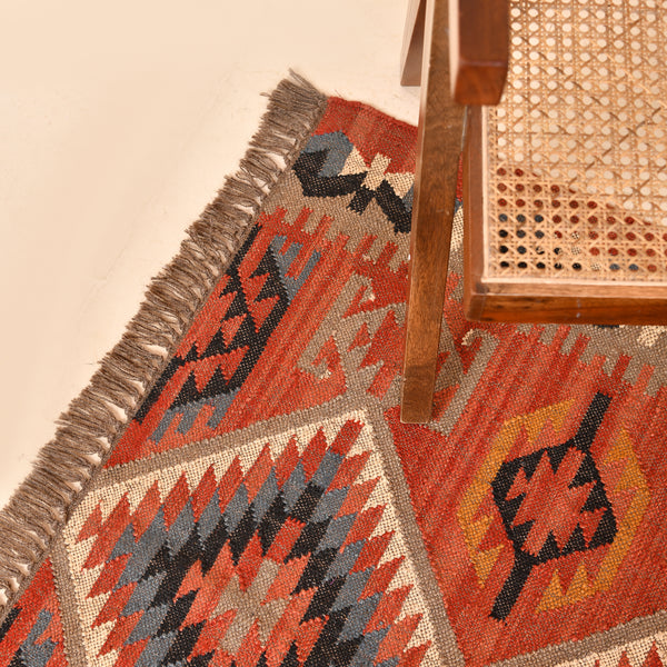 Handwoven terracotta geometric wool Kilim area rug with tribal diamond patterns and fringe, perfect for boho, farmhouse, rustic, and Southwestern home décor.