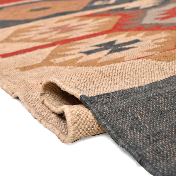 Handmade wool jute kilim area rug featuring Southwestern tribal geometric patterns in beige, charcoal, rust, and ivory for boho farmhouse home décor.