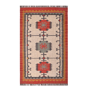 Handwoven ivory wool Kilim area rug featuring tribal geometric medallions and traditional border design, styled in a modern living room.