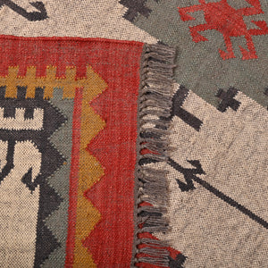 Handwoven ivory wool Kilim area rug featuring tribal geometric medallions and traditional border design, styled in a modern living room.