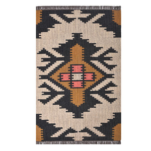 Handwoven ivory wool jute Kilim area rug featuring bold tribal geometric patterns with black, camel, and blush accents in a modern living room.
