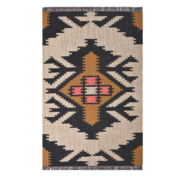 Handwoven ivory wool jute Kilim area rug featuring bold tribal geometric patterns with black, camel, and blush accents in a modern living room.