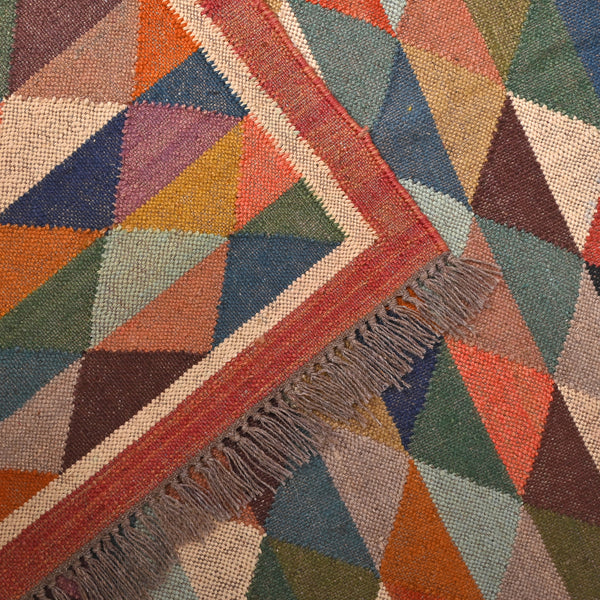 Handwoven multicolor geometric kilim area rug featuring colorful triangle patterns in wool and natural jute for living room, bedroom, hallway, and modern home décor.
