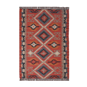 Handwoven terracotta geometric wool Kilim area rug with tribal diamond patterns and fringe, perfect for boho, farmhouse, rustic, and Southwestern home décor.