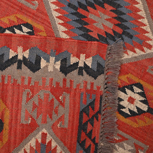 Handwoven terracotta geometric wool Kilim area rug with tribal diamond patterns and fringe, perfect for boho, farmhouse, rustic, and Southwestern home décor.