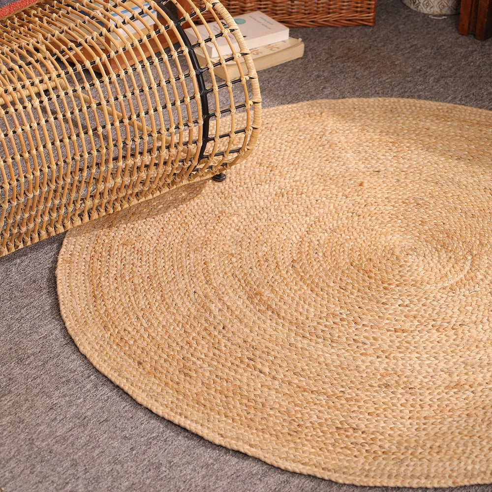 Handwoven natural round braided jute rug made from eco-friendly natural fibers for boho farmhouse and modern home décor.