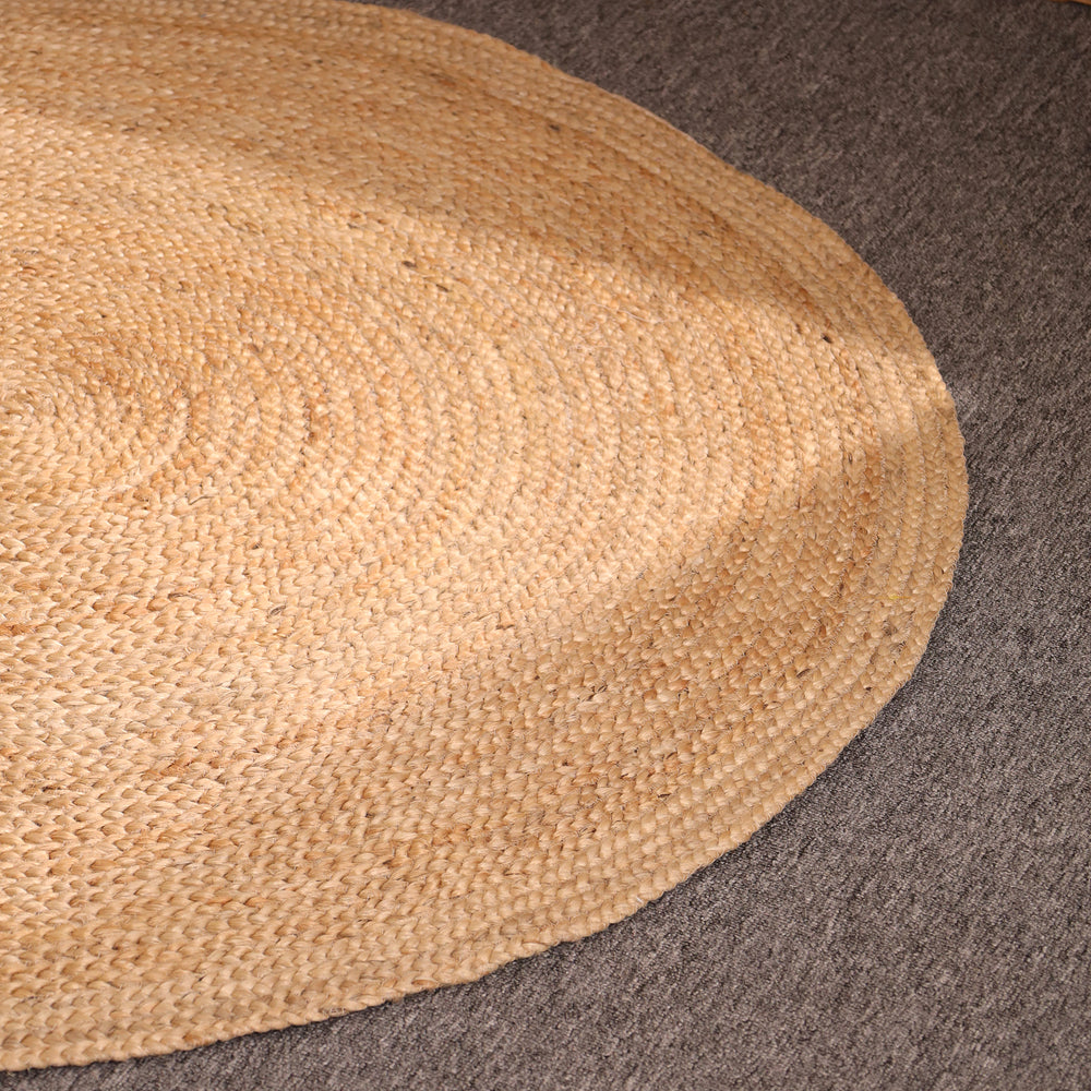 Handwoven natural round braided jute rug made from eco-friendly natural fibers for boho farmhouse and modern home décor.