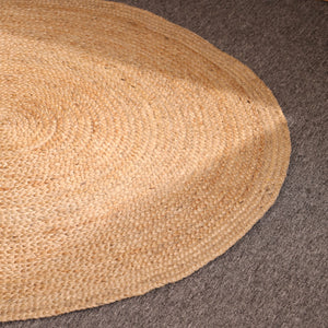 Handwoven natural round braided jute rug made from eco-friendly natural fibers for boho farmhouse and modern home décor.