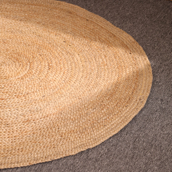Handwoven natural round braided jute rug made from eco-friendly natural fibers for boho farmhouse and modern home décor.