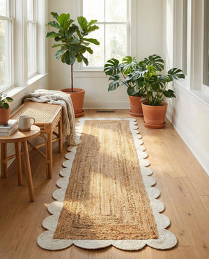 Handwoven natural jute runner rug with a white scalloped braided border